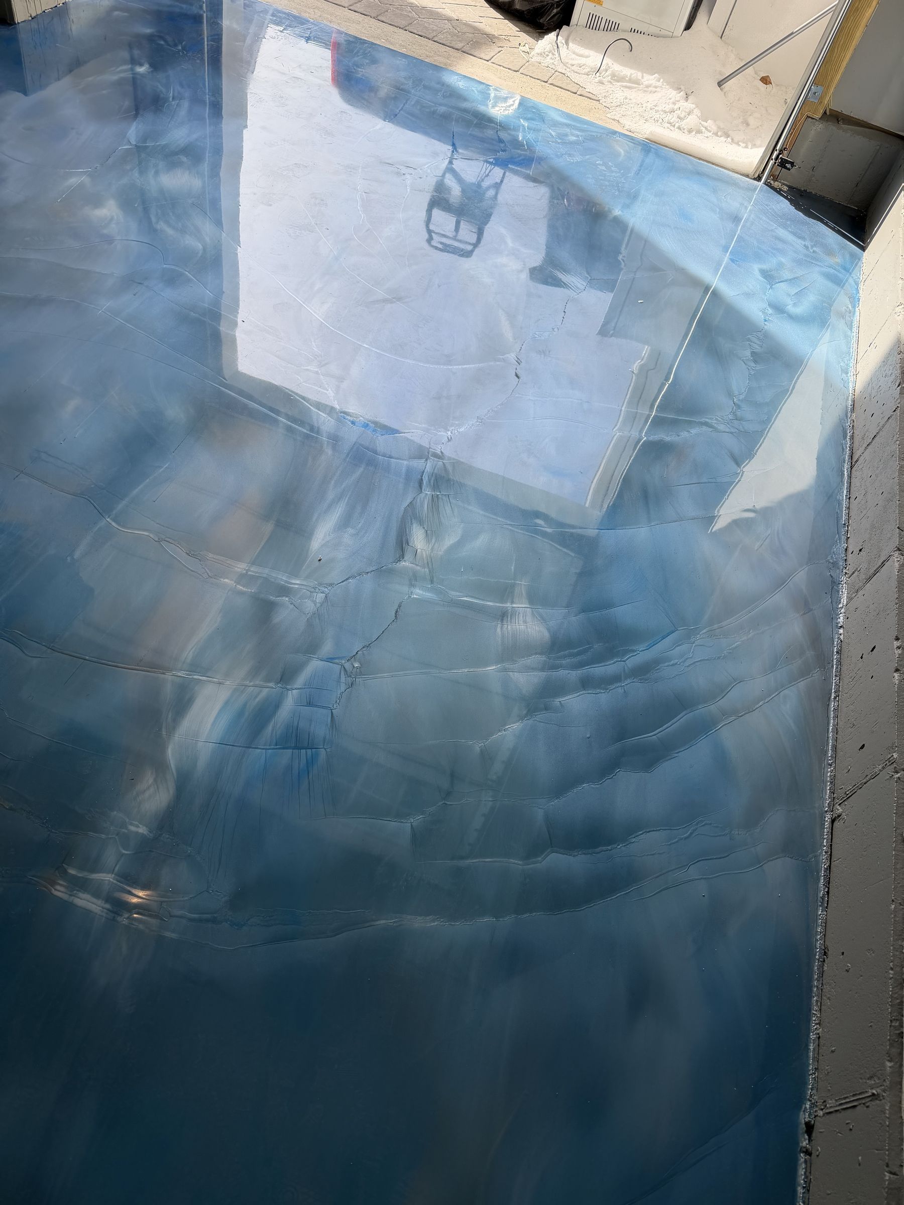 Glossy blue and white metallic epoxy garage floor we installed