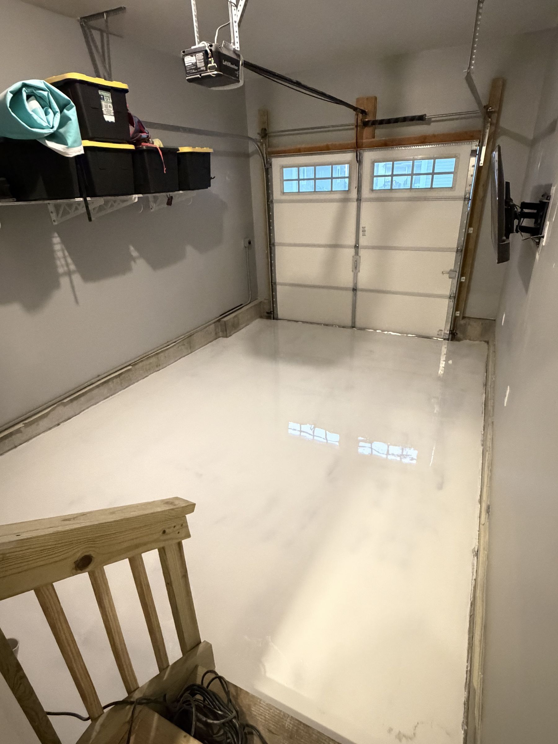 After: the same garage with a finished glossy white metallic epoxy floor